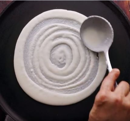 What are the benefits of cooking in a Cast Iron Dosa Pan?